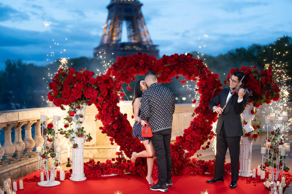 Romantic marriage proposal on Bir-Hakeim Bridge in Paris with Eiffel Tower in the background and elegant arches overhead