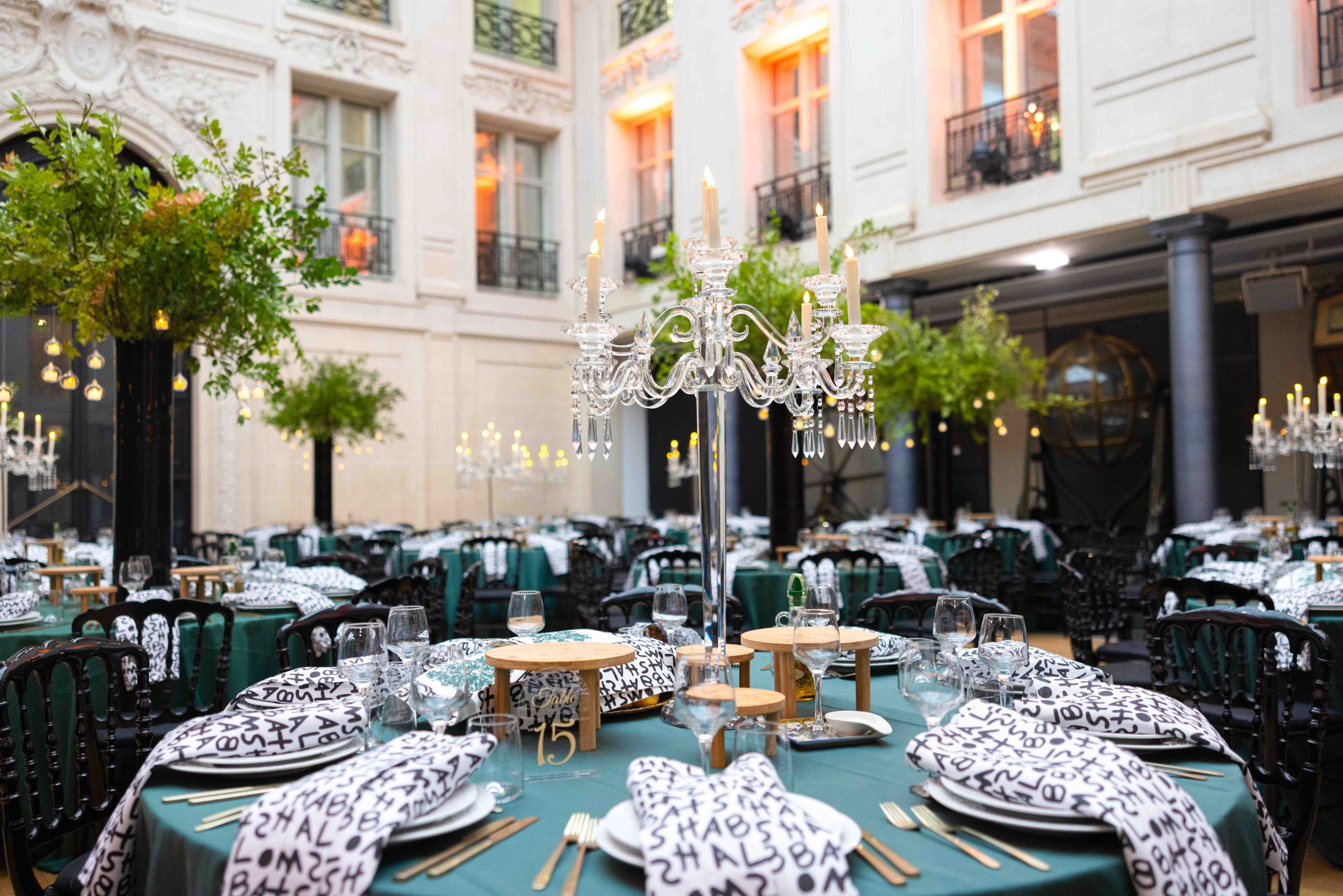 Luxury event setup in Paris with Bella crystal chandelier centerpiece and 9 candles.